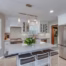 Bright kitchen featuring recessed lighting, pendant lights, and layered illumination that supports aging-in-place design.